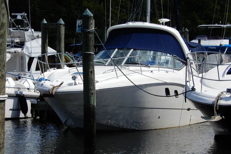 Slide: The Image of 2008 Sea Ray Sundancer 330 yacht docked at marina, featuring sleek white design. - 3