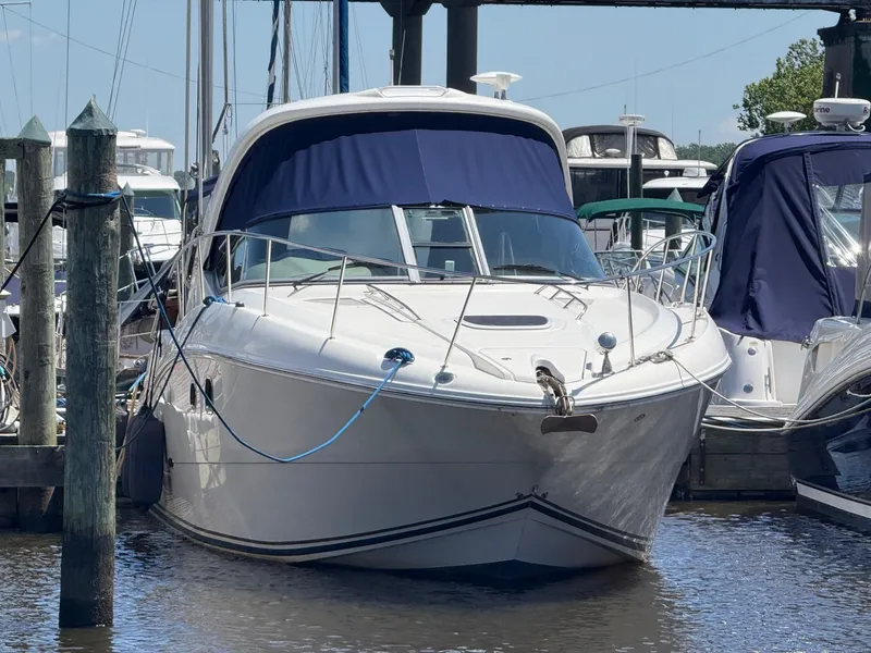 Slide: The Image of 2008 Sea Ray 330 Sundancer docked at marina, featuring sleek design and blue canopy. - 2