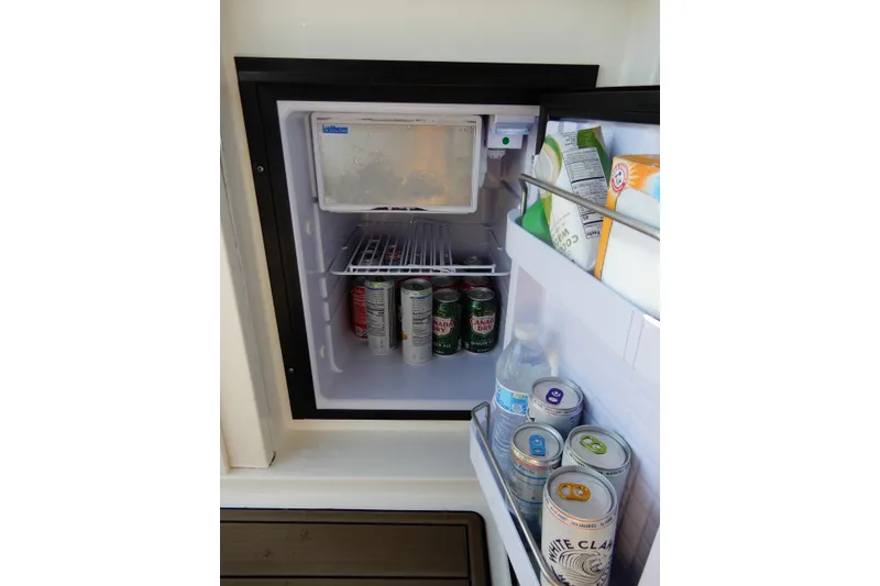 Slide: The Image of Mini fridge stocked with drinks on a 2008 Sea Ray Sundancer 330 boat. - 18