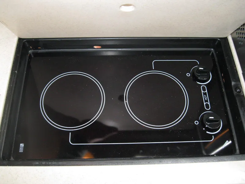 Slide: The Image of Stovetop on 2008 Sea Ray 330 Sundancer yacht, featuring two burners and control knobs. - 46