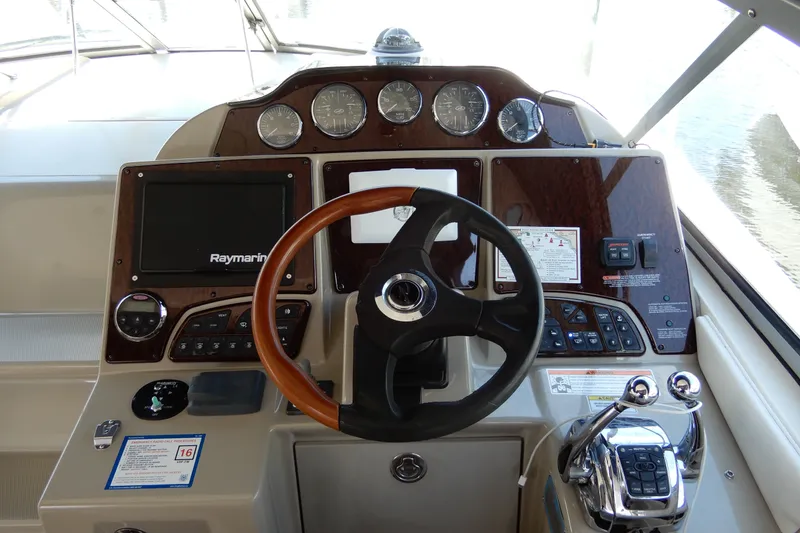 Slide: The Image of Cockpit of 2008 Sea Ray Sundancer 330 with steering wheel and Raymarine navigation system. - 31