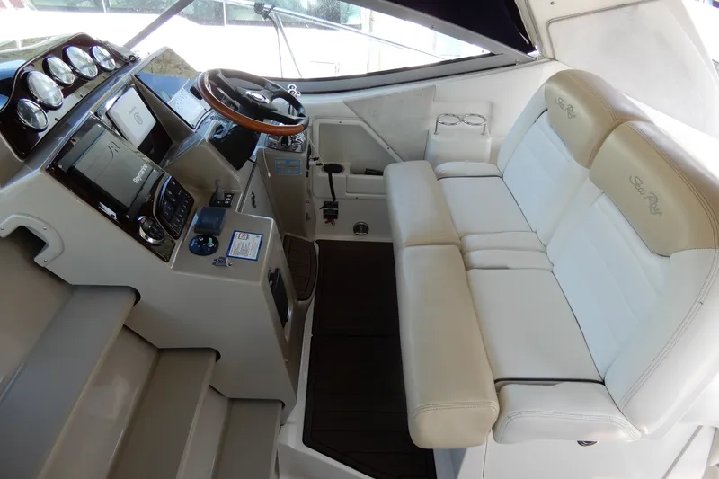 Slide: The Image of 2008 Sea Ray Sundancer 330 helm with leather seating and modern navigation controls. - 25