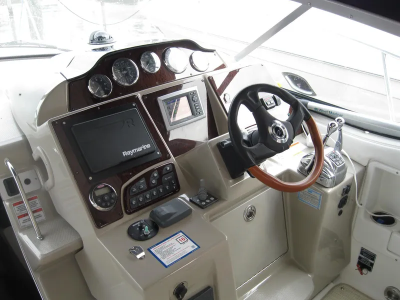Slide: The Image of 2008 Sea Ray 330 Sundancer helm with Raymarine electronics and wood-accented steering wheel. - 29