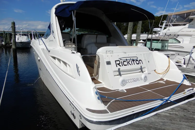 Slide: The Image of 2008 Sea Ray Sundancer 330 docked, featuring sleek design and spacious deck. - 5