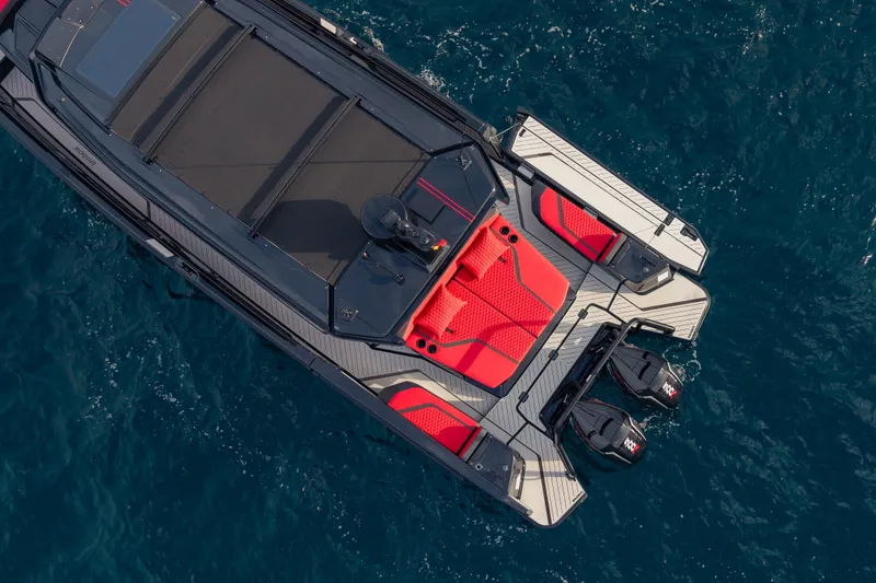Slide: The Image of Aerial view of 2027 BRABUS 1000 luxury boat with red seating on blue water. - 12