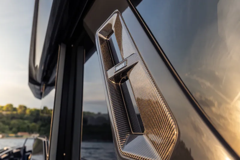 Slide: The Image of Close-up of a 2027 BRABUS 1000 yacht's sleek carbon fiber detail at sunset. - 20