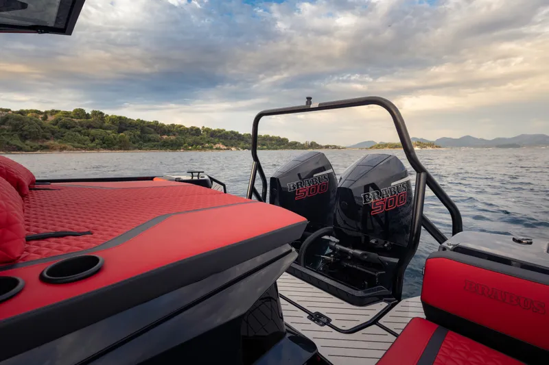 Slide: The Image of Luxurious 2027 BRABUS 1000 boat with dual engines and red seating on a scenic lake. - 14