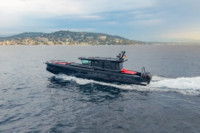Slide: The Image of 2027 BRABUS 1000 luxury yacht cruising on open water near coastal cityscape. - 3