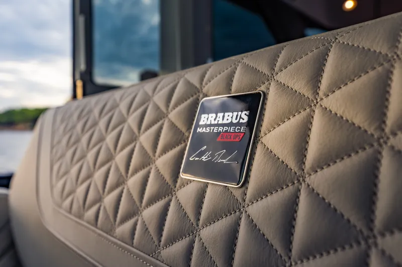 Slide: The Image of Luxurious quilted leather interior of 2027 BRABUS 1000, featuring Masterpiece Black Ops badge. - 33