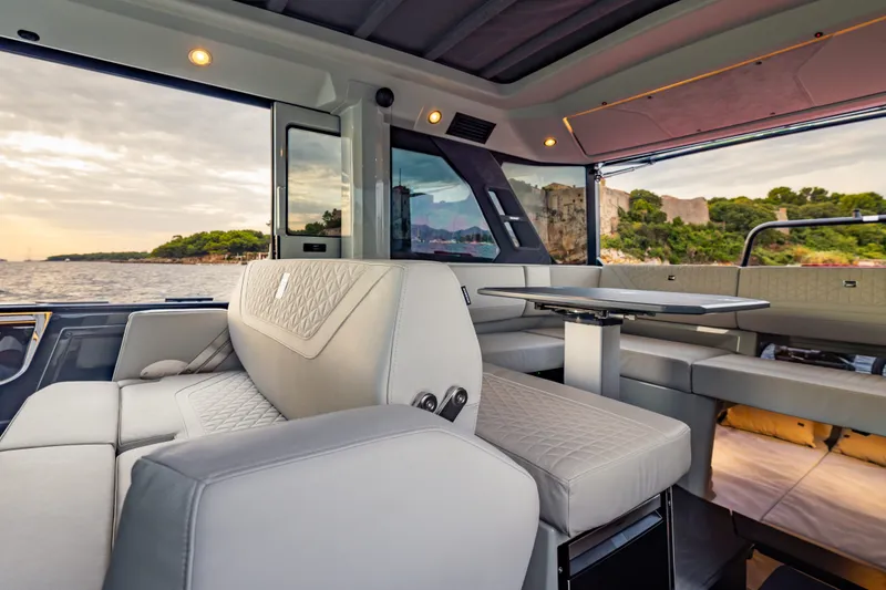 Slide: The Image of Luxurious interior of 2027 BRABUS 1000 yacht with elegant seating and scenic ocean view. - 30