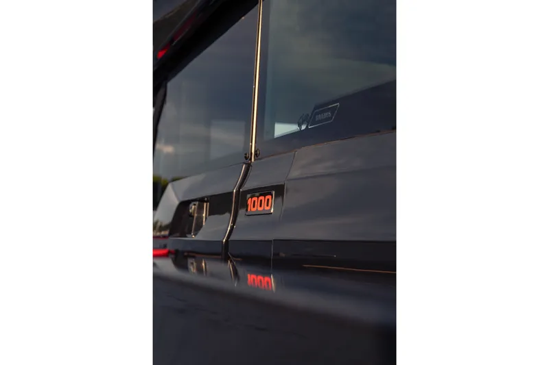 Slide: The Image of Close-up of 2027 BRABUS 1000 badge on sleek black vehicle exterior. - 22