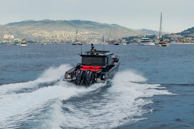 Slide: The Image of BRABUS 1000 boat cruising in scenic waters, 2027 model, with yachts in the background. - 7