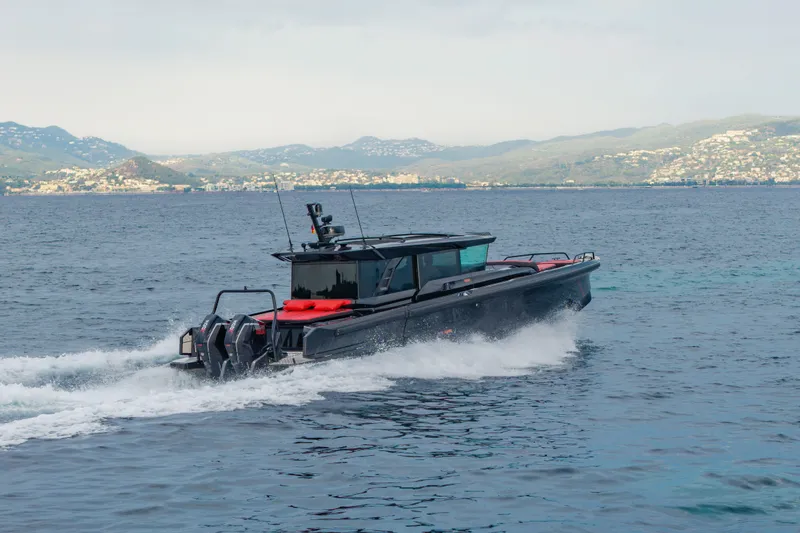 Slide: The Image of The 2027 BRABUS 1000 XC Cross Cabin speeds across the water with a scenic coastline in the background. - 8