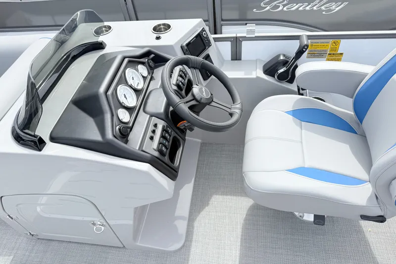 Slide: The Image of 2027 Bentley Pontoons Legacy 223 Navigator helm with steering wheel and control panel. - 10