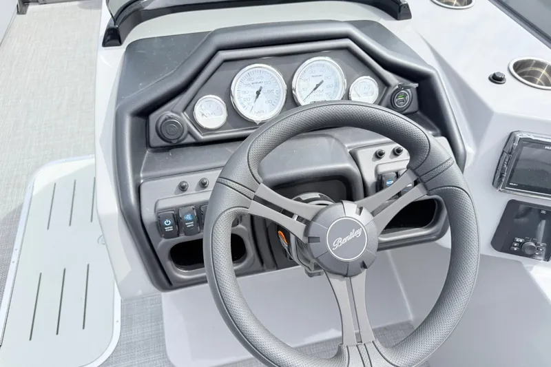 Slide: The Image of Steering console of 2027 Bentley Pontoons Legacy 223 Navigator with gauges and controls. - 13
