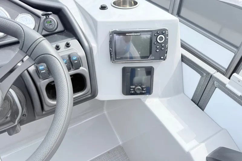 Slide: The Image of 2027 Bentley Pontoons Legacy 223 Navigator dashboard with steering wheel and navigation controls. - 12