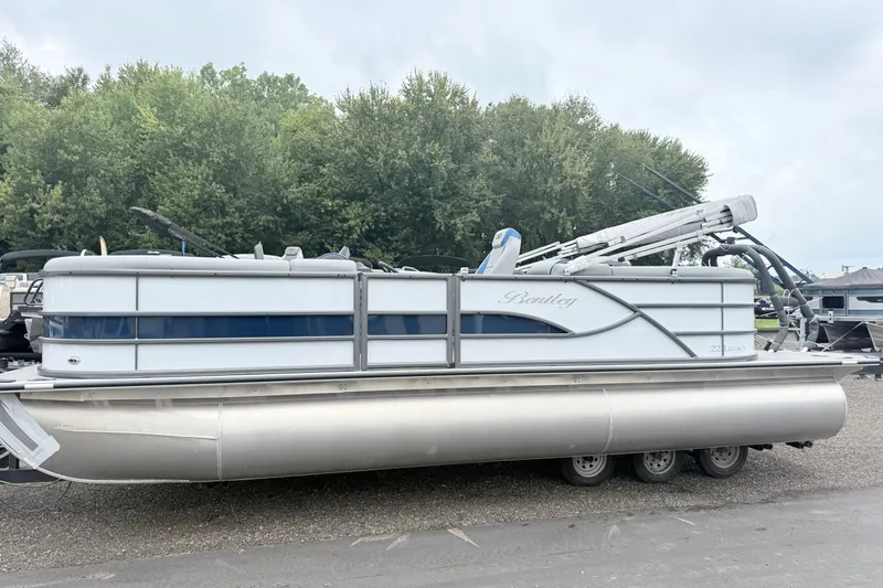 The Image of 2027 Bentley Pontoons Legacy 223 Navigator pontoon boat parked outdoors. - 0