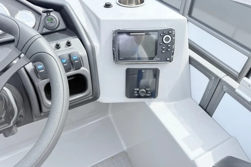 Slide: The Image of Steering console of 2027 Bentley Pontoons Legacy 223 Navigator with navigation controls. - 11