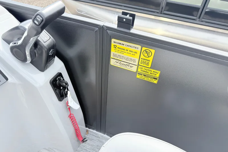 Slide: The Image of 2027 Bentley Pontoons Bolt 223 control panel with capacity and safety warnings. - 9