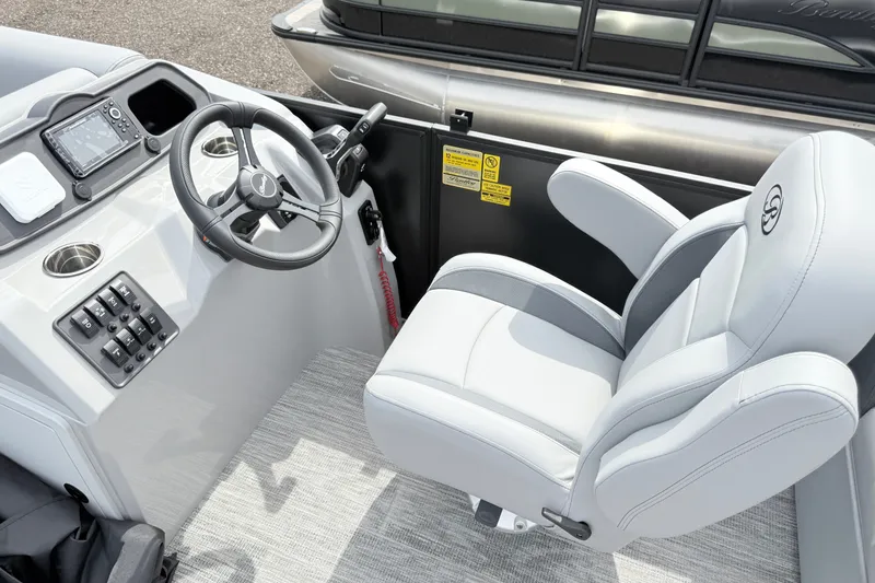 Slide: The Image of 2027 Bentley Pontoons Bolt 223 helm with steering wheel, control panel, and captain's chair. - 8