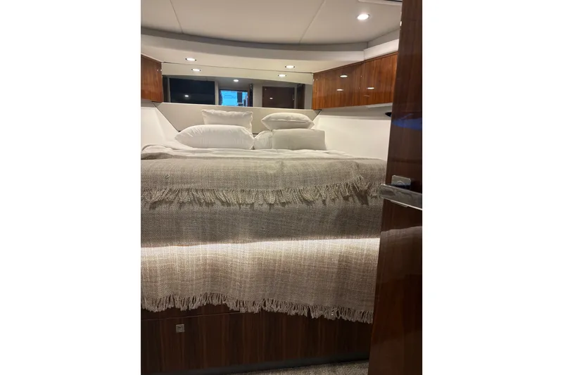 Slide: The Image of Luxurious bedroom interior of 2025 Riviera 46 Sports Motor Yacht with elegant bedding. - 16