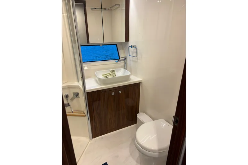 Slide: The Image of Luxurious bathroom in 2025 Riviera 46 Sports Motor Yacht with modern fixtures and elegant design. - 15