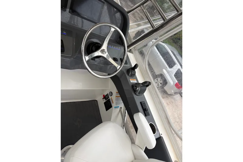 Slide: The Image of Helm of 2025 Riviera 46 Sports Motor Yacht with steering wheel and controls. - 18