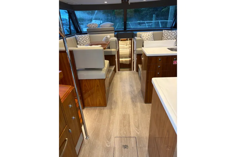 Slide: The Image of Luxurious interior of 2025 Riviera 46 Sports Motor Yacht with elegant seating and wood finishes. - 8