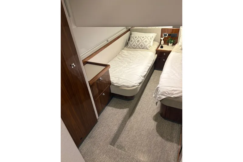 Slide: The Image of Luxurious cabin interior of 2025 Riviera 46 Sports Motor Yacht with twin beds. - 13
