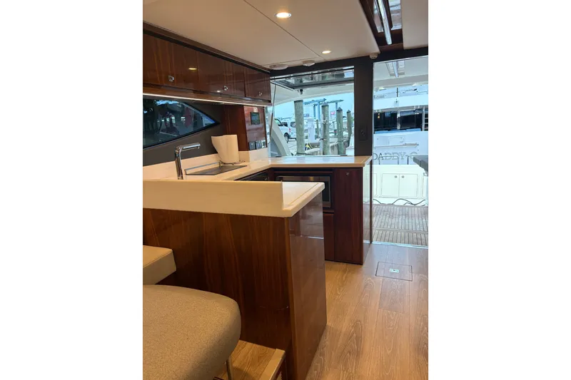 Slide: The Image of Luxurious interior of 2025 Riviera 46 Sports Motor Yacht with modern kitchen design. - 10