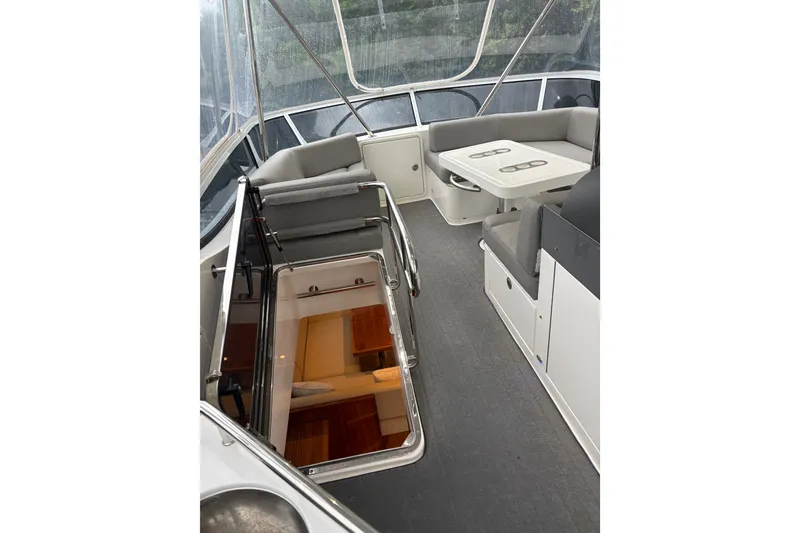 Slide: The Image of 2025 Riviera 46 Sports Motor Yacht interior with seating and table, showcasing luxury design. - 20