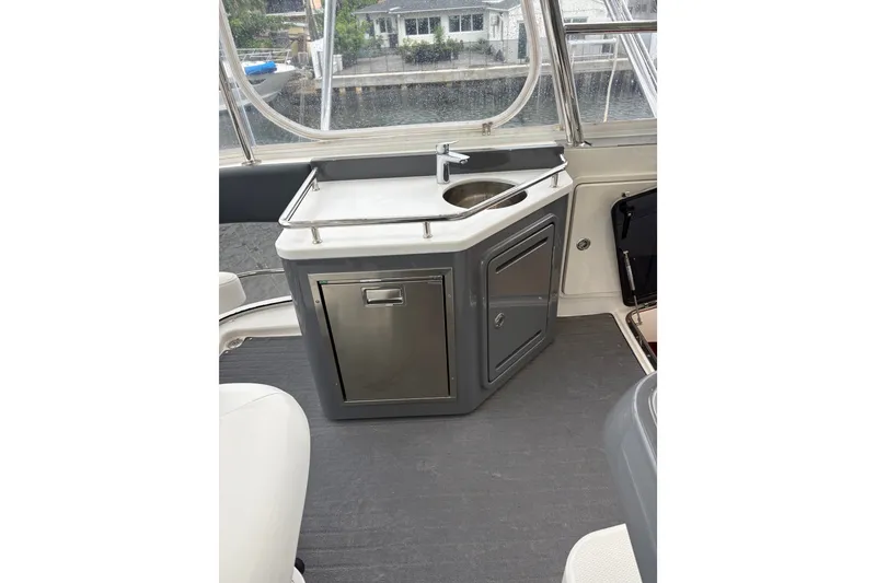 Slide: The Image of Interior view of 2025 Riviera 46 Sports Motor Yacht with compact kitchenette and sink. - 22