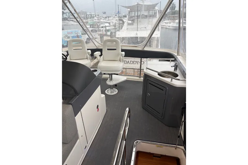 Slide: The Image of Interior view of 2025 Riviera 46 Sports Motor Yacht with helm and seating area. - 24