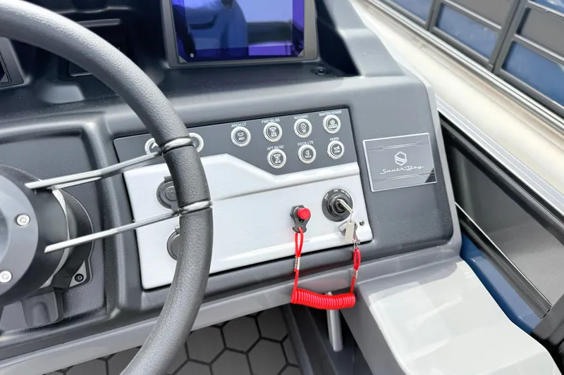Slide: The Image of Steering console of 2026 South Bay 525UL DC boat with control panel and ignition. - 14