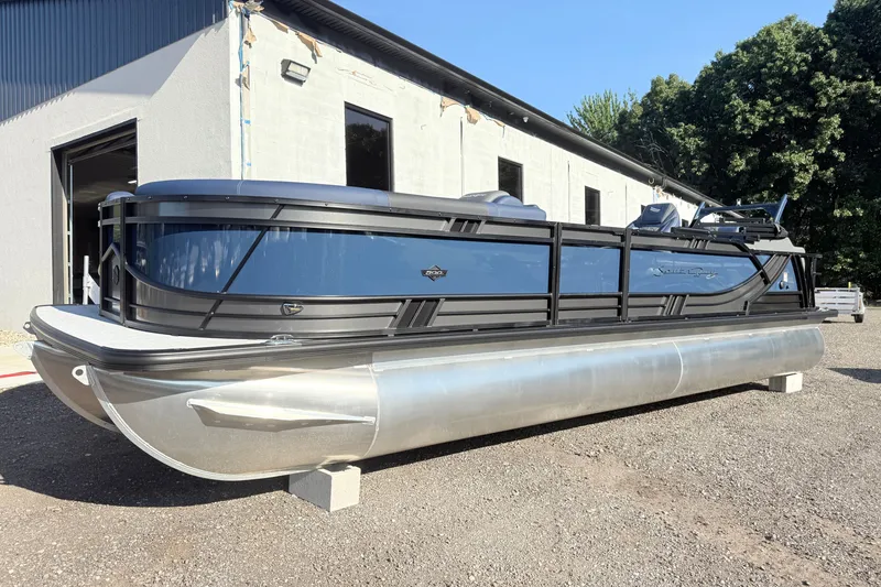 Slide: The Image of 2026 South Bay 525UL DC pontoon boat parked outdoors. - 2