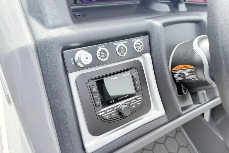 Slide: The Image of Control panel of 2026 South Bay 525UL DC boat with audio system and lighting controls. - 15