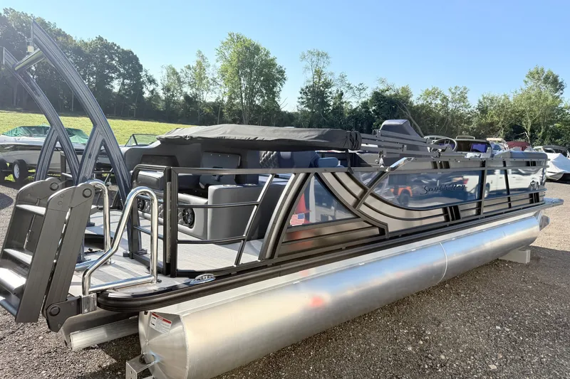Slide: The Image of 2026 South Bay 525UL DC pontoon boat with sleek design, parked outdoors. - 5