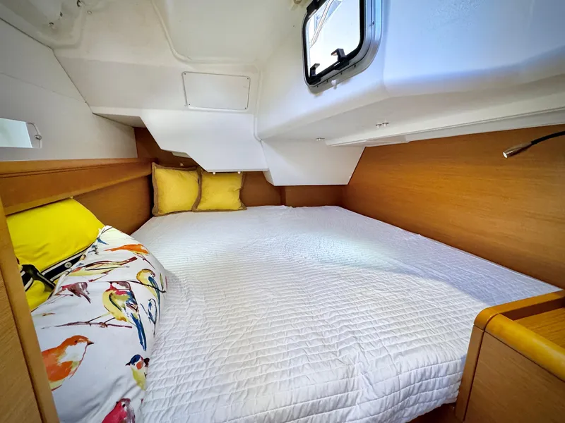 Slide: The Image of Cozy cabin interior of 2015 Jeanneau Sun Odyssey 379 sailboat with colorful bedding. - 48