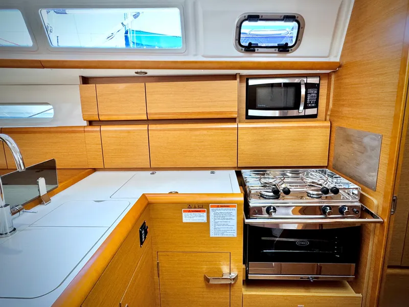 Slide: The Image of Modern kitchen in 2015 Jeanneau Sun Odyssey 379 yacht with stove and microwave. - 44