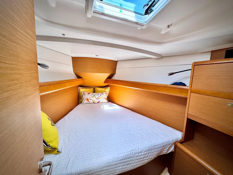 Slide: The Image of Cozy cabin interior of 2015 Jeanneau Sun Odyssey 379 sailboat with skylight and wooden finish. - 4