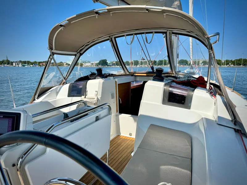 Slide: The Image of 2015 Jeanneau Sun Odyssey 379 sailboat cockpit with canopy, on a sunny day. - 2