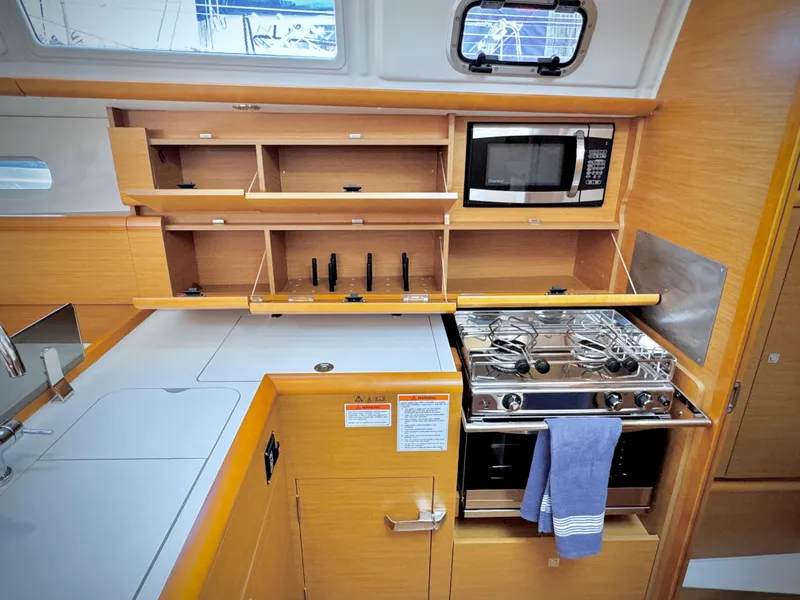 Slide: The Image of Modern kitchen in 2015 Jeanneau Sun Odyssey 379 sailboat with stove, microwave, and storage. - 45