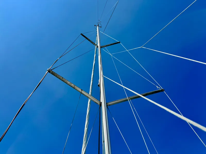 Slide: The Image of Mast of 2015 Jeanneau Sun Odyssey 379 sailboat against clear blue sky. - 14