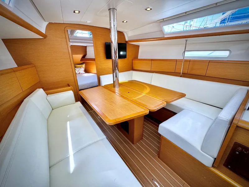 Slide: The Image of Interior of 2015 Jeanneau Sun Odyssey 379 sailboat with modern seating and wooden finishes. - 34