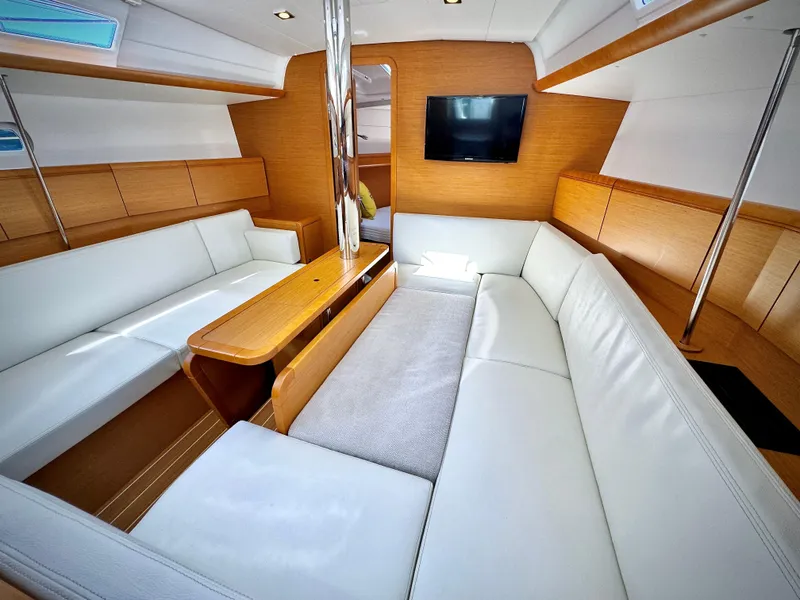 Slide: The Image of Interior of 2015 Jeanneau Sun Odyssey 379 yacht with white seating and wooden accents. - 36