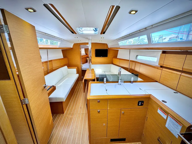 Slide: The Image of Interior of 2015 Jeanneau Sun Odyssey 379 sailboat, featuring modern wood finish and spacious layout. - 31