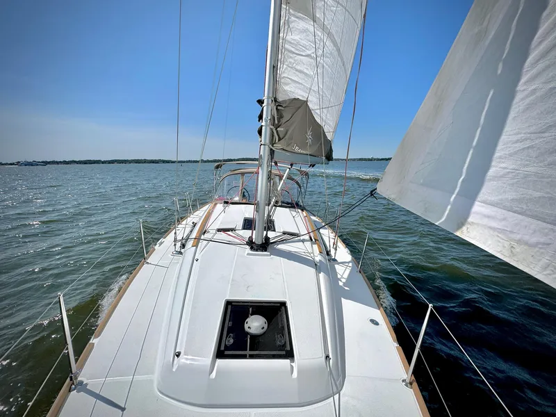 Slide: The Image of 2015 Jeanneau Sun Odyssey 379 sailing on open water under clear blue skies. - 8