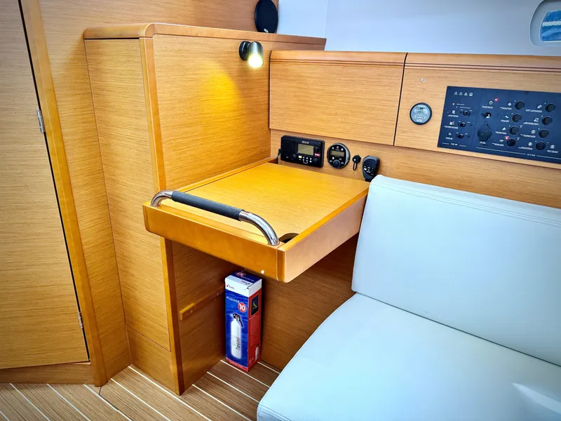 Slide: The Image of Interior of 2015 Jeanneau Sun Odyssey 379, featuring navigation station and control panel. - 42
