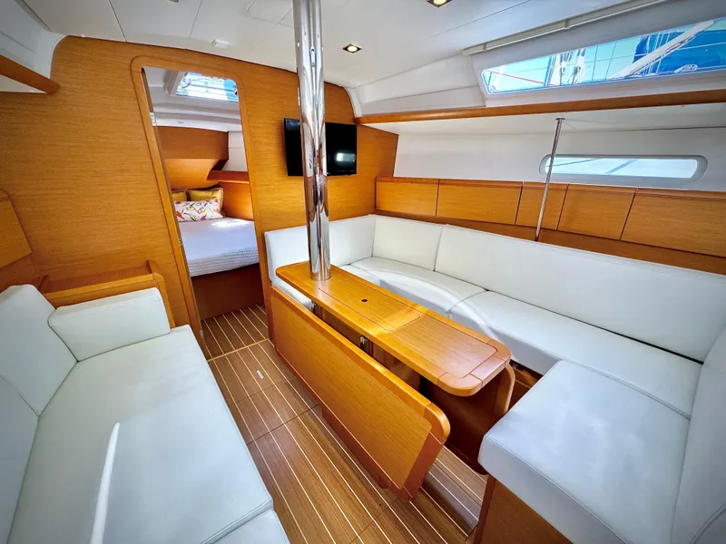Slide: The Image of Interior of 2015 Jeanneau Sun Odyssey 379 sailboat with modern wood and white seating. - 33
