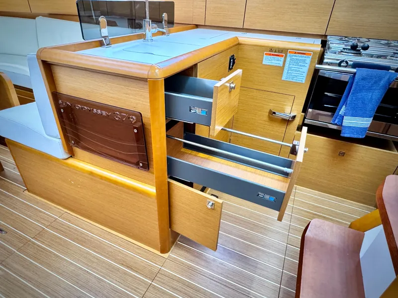 Slide: The Image of Interior of 2015 Jeanneau Sun Odyssey 379 yacht with open drawers and modern kitchen. - 47